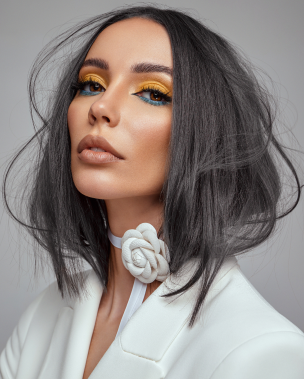 a beautiful wooman person with black hair and yellow makeup wow